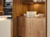 Eine moderne Küche mit Holzschränken und integriertem Backofen von Nolte Küchen.