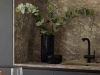 Une cuisine élégante avec effet marbre et robinet noir, agrémentée de plantes vertes. Nolte Kitchen.