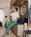 A woman in sportswear drinks water in a modern living space with Nolte Living.