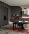 Une cuisine moderne avec des armoires sombres et une table élégante. Nolte Küchen.
