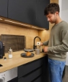 A man making coffee in a modern Nolte Kitchen kitchen.