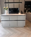 Cuisine moderne avec îlot et vases de fleurs, conçue par Nolte Kitchen.