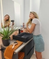 A woman dries her hair in a stylish bathroom with black furniture. Nolte SPA.
