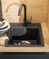 A modern kitchen with a black sink and wooden countertop by Nolte Kitchen.
