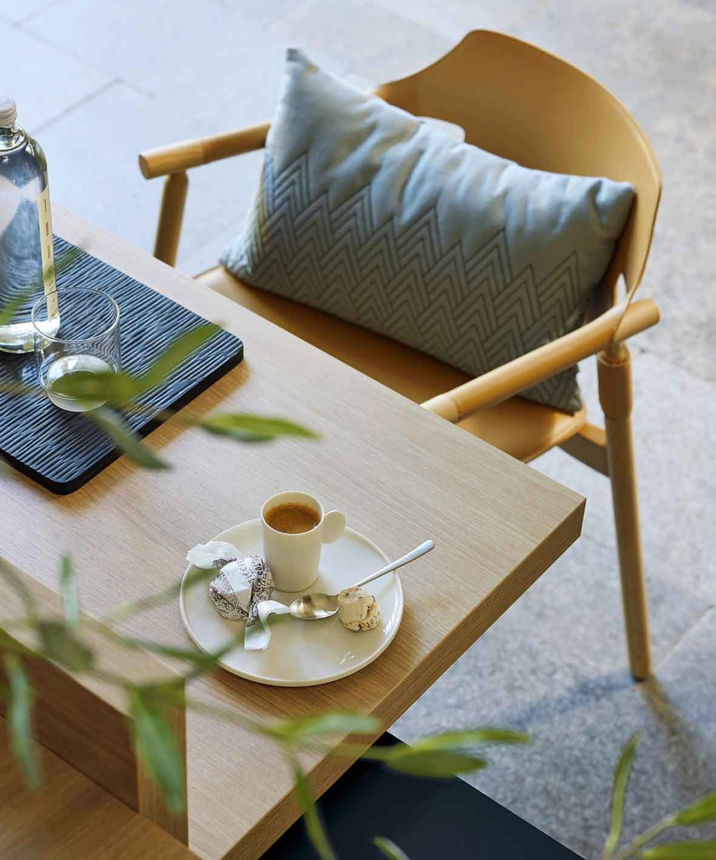 Eine moderne Sitzgruppe mit Tisch und Stuhl, dekoriert mit Kissen, im stilvollen Design von Nolte Living.