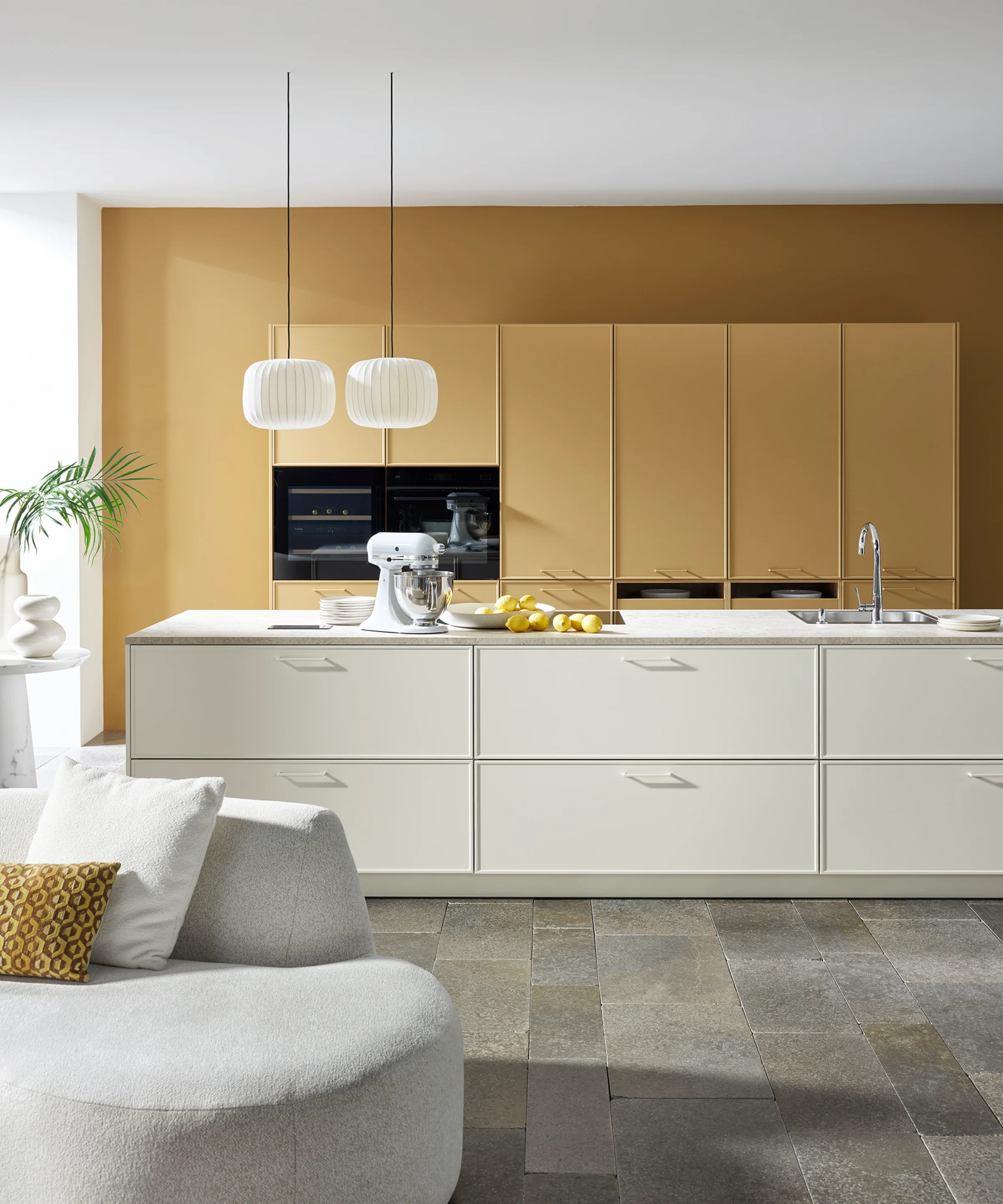 A modern kitchen with white cabinets and an island by Nolte Küchen.