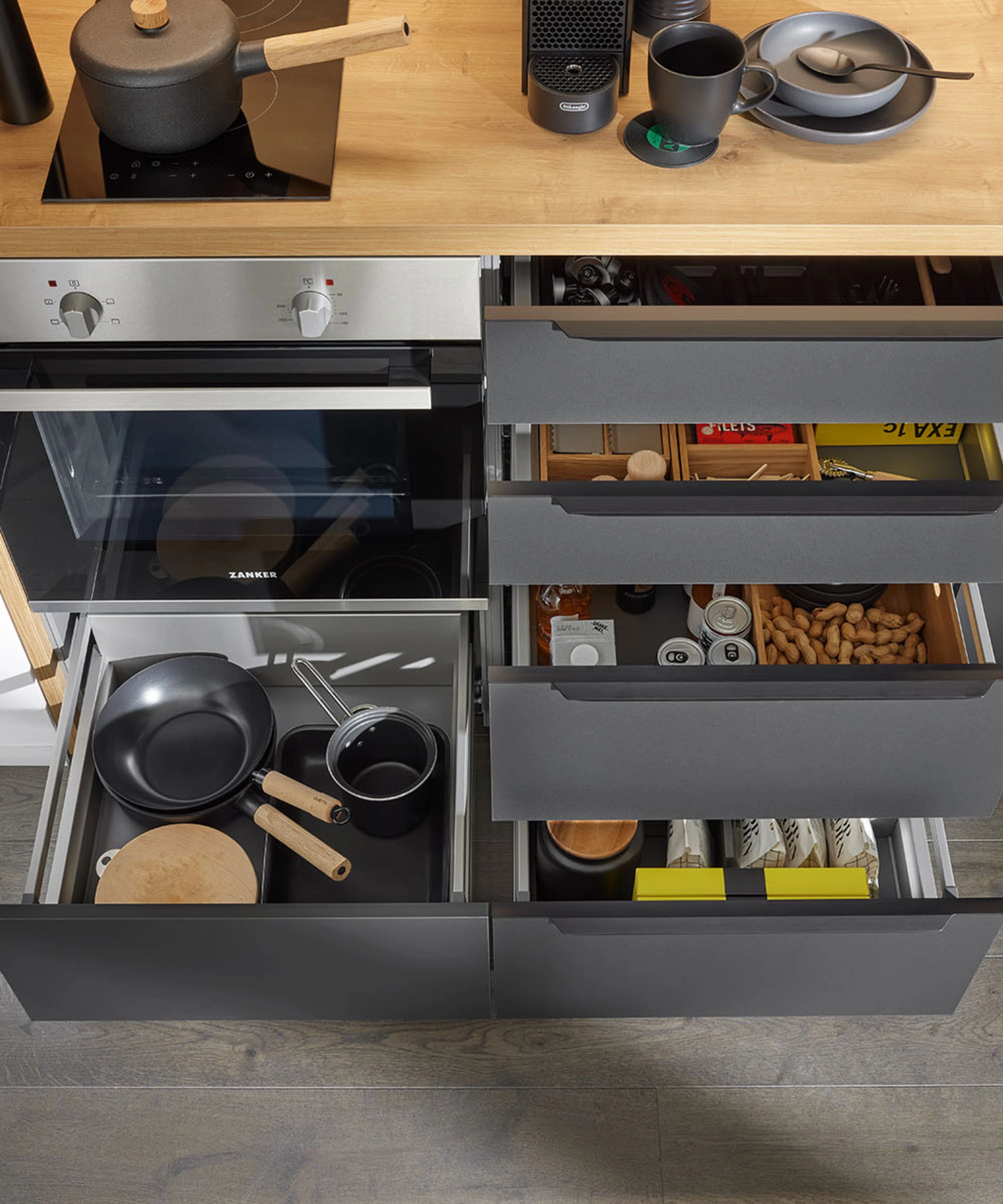 A modern kitchen with open drawers and utensils from Nolte Kitchen.