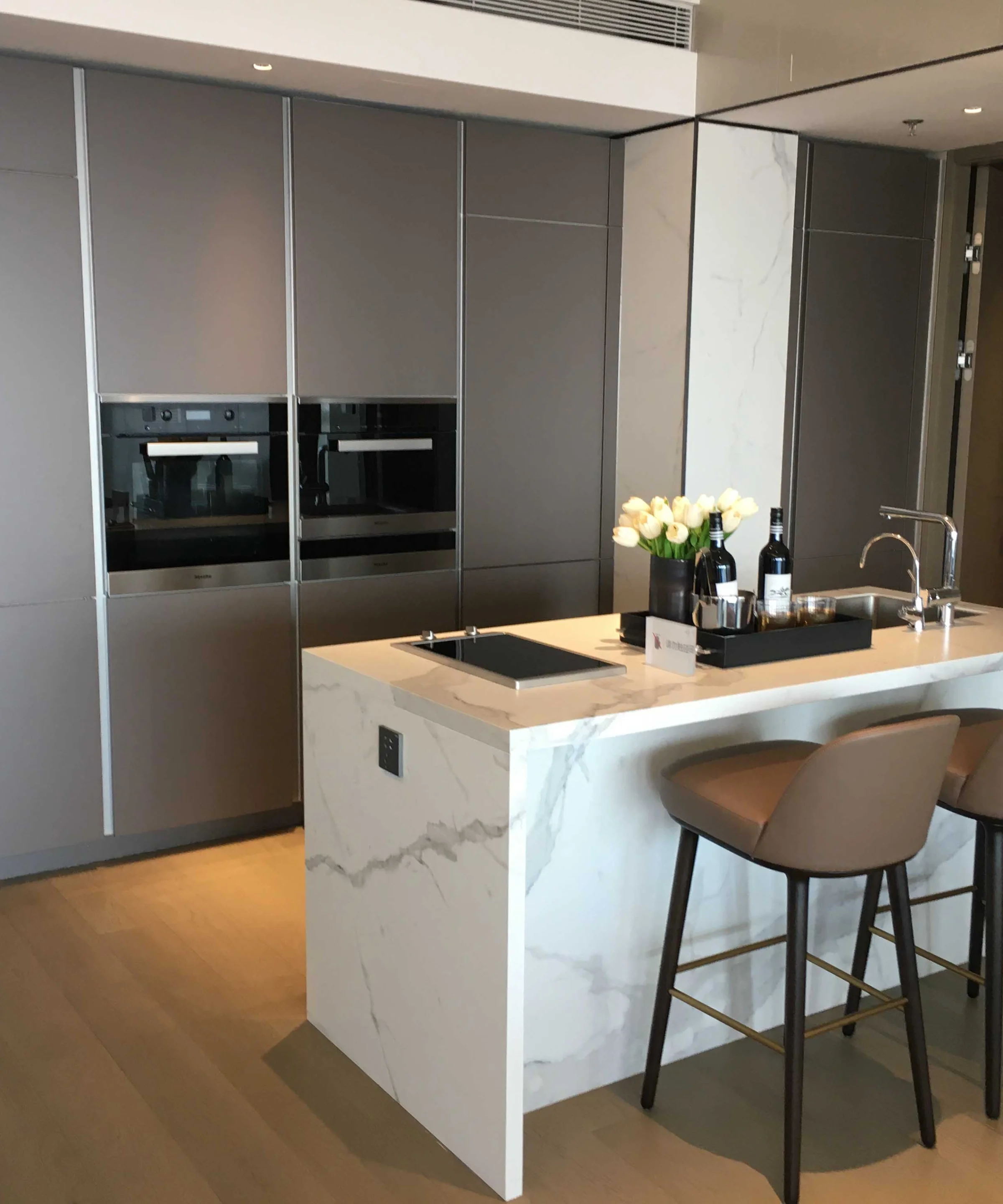 A modern kitchen with a central island and sleek appliances from Nolte Kitchen.