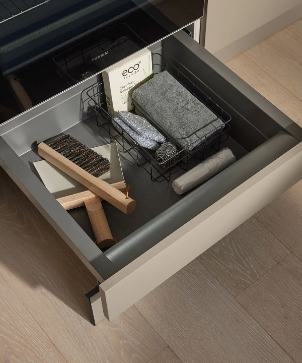 An open kitchen drawer with utensils, integrated into a modern Nolte Kitchen design.