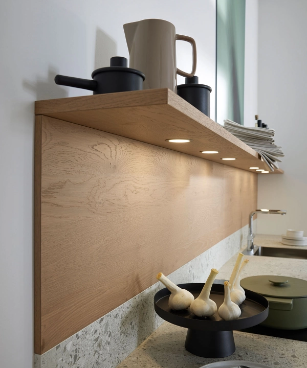 Étagère de cuisine avec vaisselle et déco, plan de travail éclairé en dessous. Nolte Kitchen.